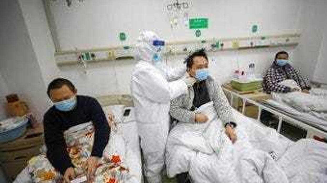 A doctor checks the conditions of a patient in Jinyintan Hospital, designated for critical COVID-19 patients, in Wuhan in central China's Hubei province Thursday, Feb. 13, 2020. (Chinatopix Via AP)