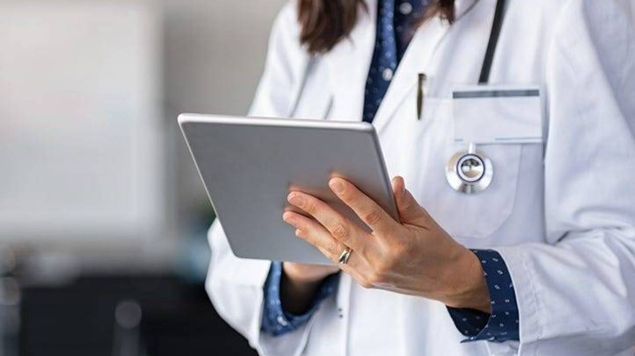 A doctor using a tablet