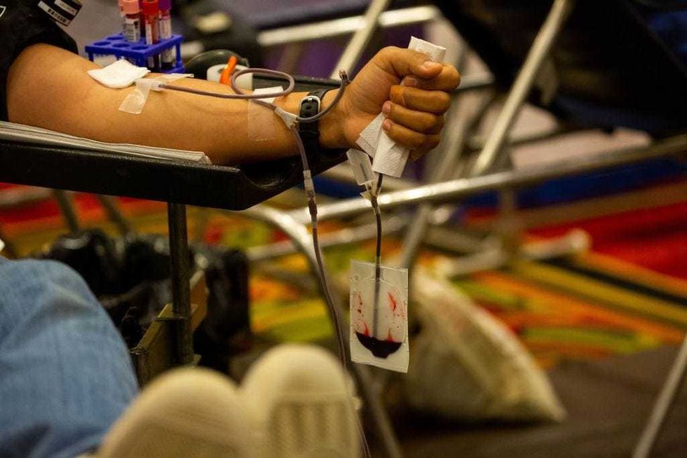 A donor gives blood at an emergency blood drive hosted by the NYBC and the New York Islanders on World Blood Donor Day in Uniondale, New York on June 14, 2021.