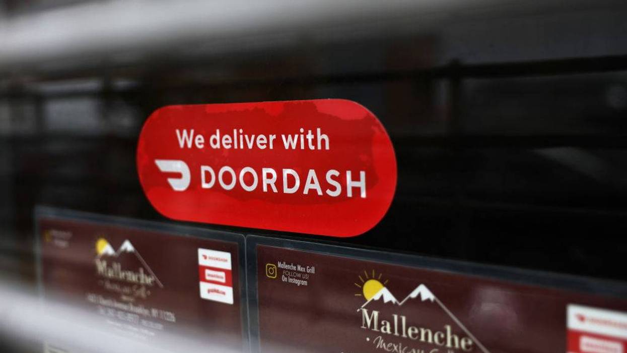 A Doordash sticker is seen on a window