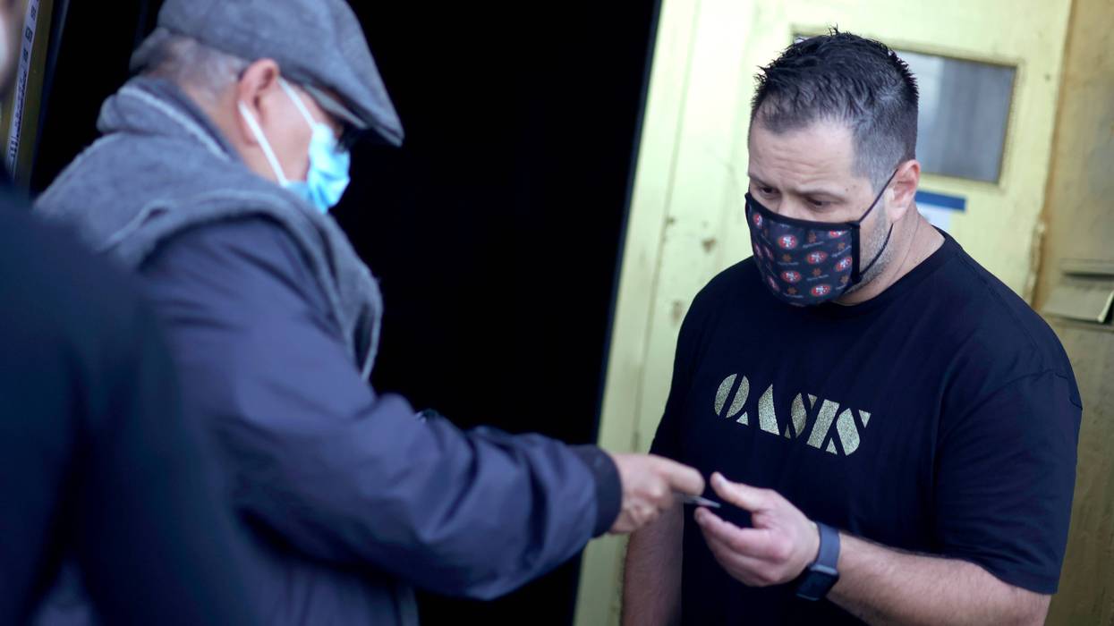 A doorman at Oasis checks a customer's vaccination card before allowing him to enter on July 29, 2021 in San Francisco,