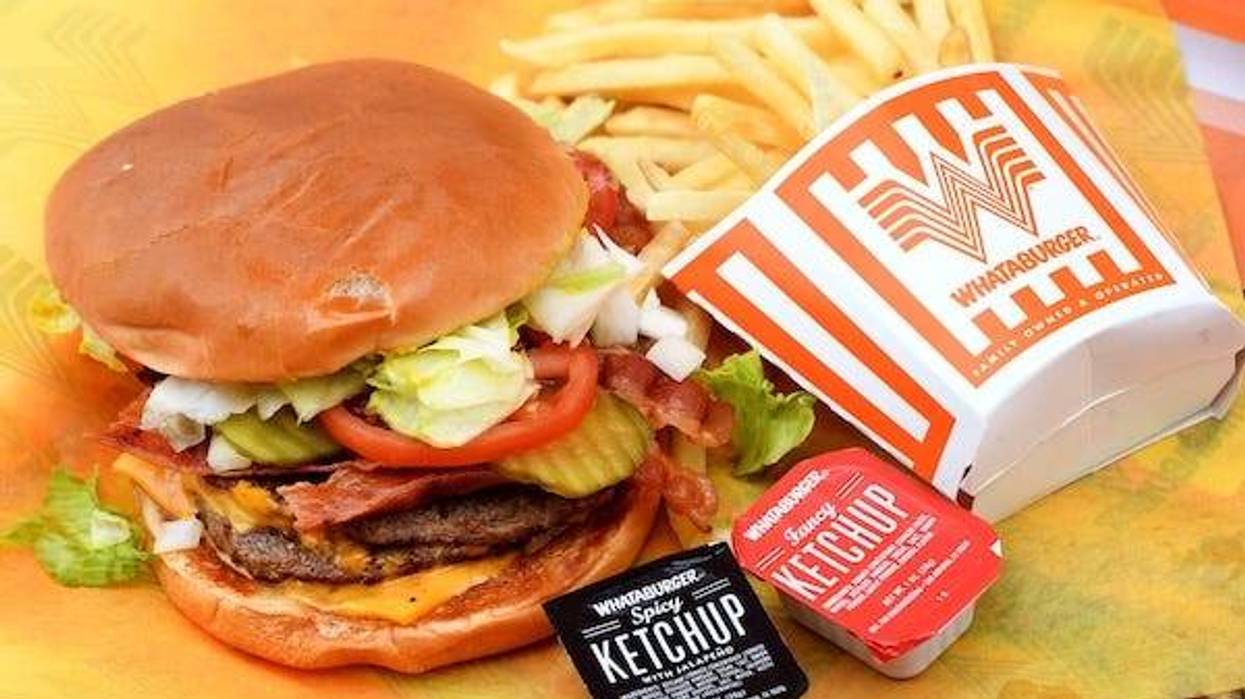 A double meat Whataburger with cheese and bacon, with a side of fries