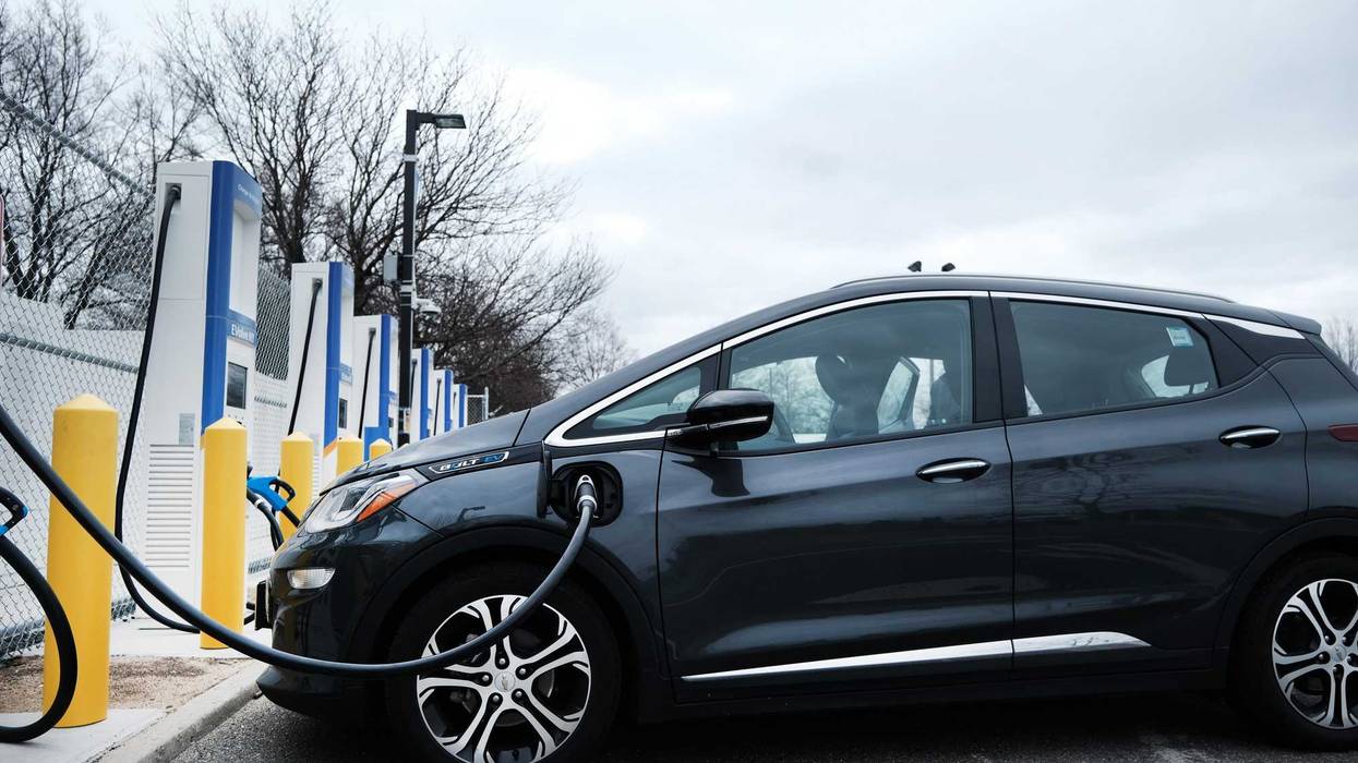 A driver uses a fast-charging station for electric in the cell phone lot at John F. Kennedy (JFK) airport on April 02, 2021.