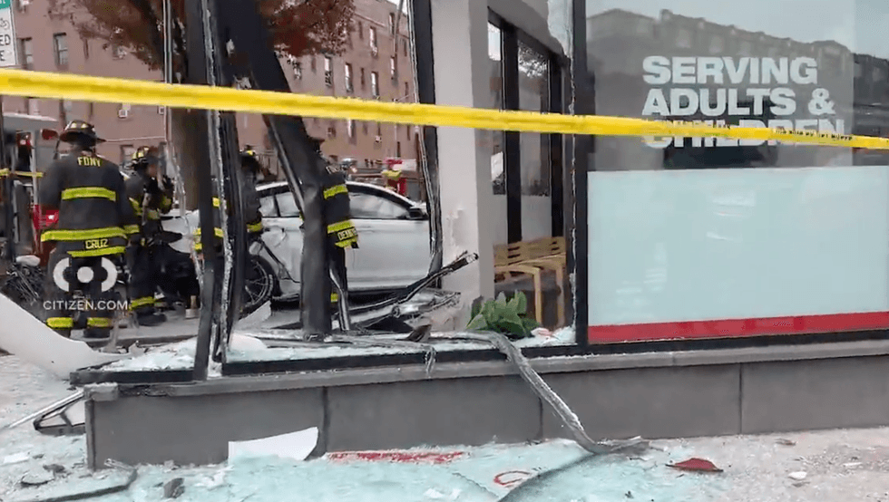 A driver was charged with four counts of reckless endangerment after smashing a car into the side of a Queens urgent care and sending four people to the hospital on Saturday morning, officials said.