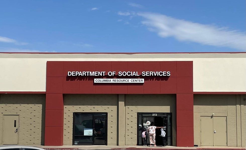 A family enters the Missouri Department of Social Services resource center in Columbia