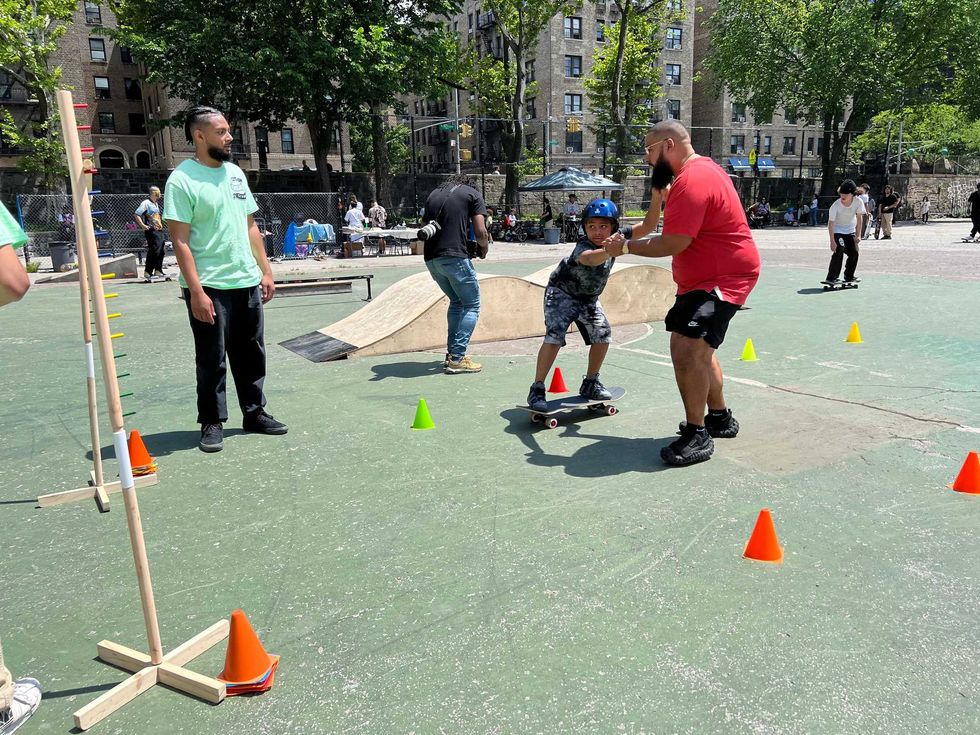A father helping his son on the board for the first time