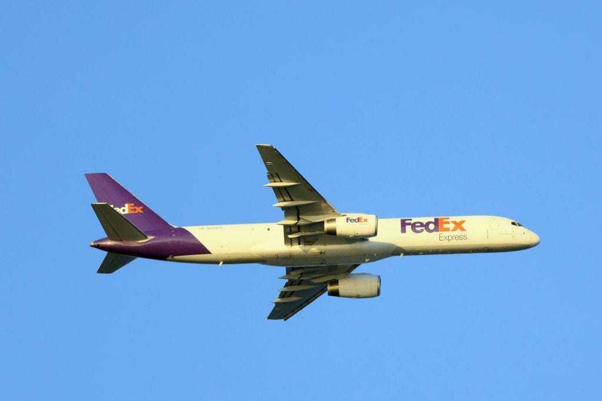 A Federal Express cargo plane flies over Nickerson Beach on July 20, 2022 in Lido Beach, New York, United States.