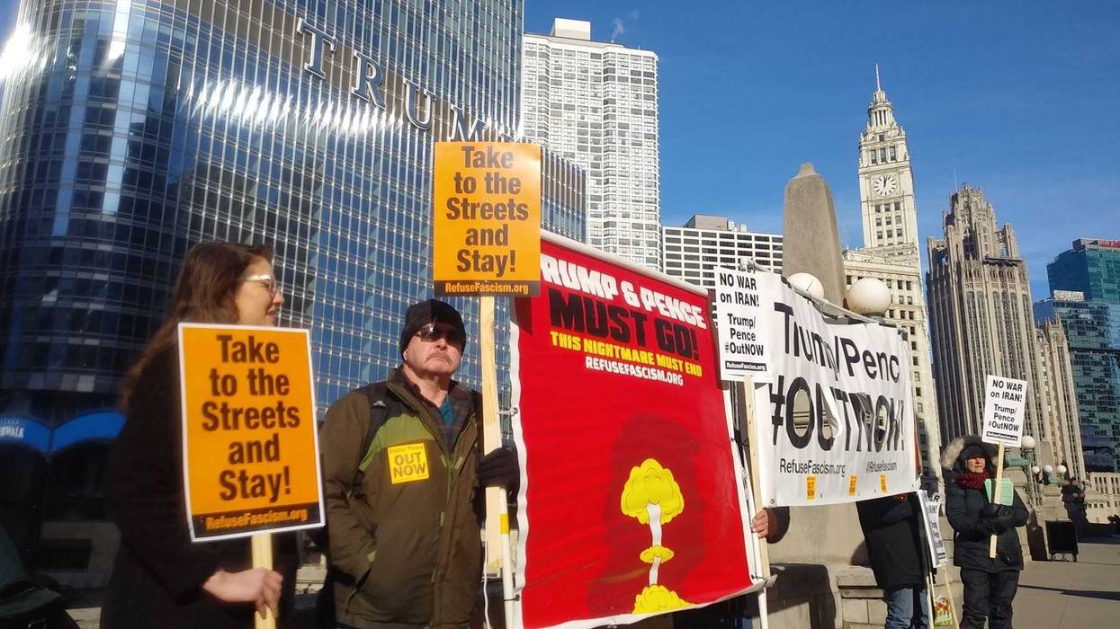A few dozen protesters stood across the river from Trump Tower and then marched through the cold downtown, chanting and carrying signs saying "Trump, Pence out now!"