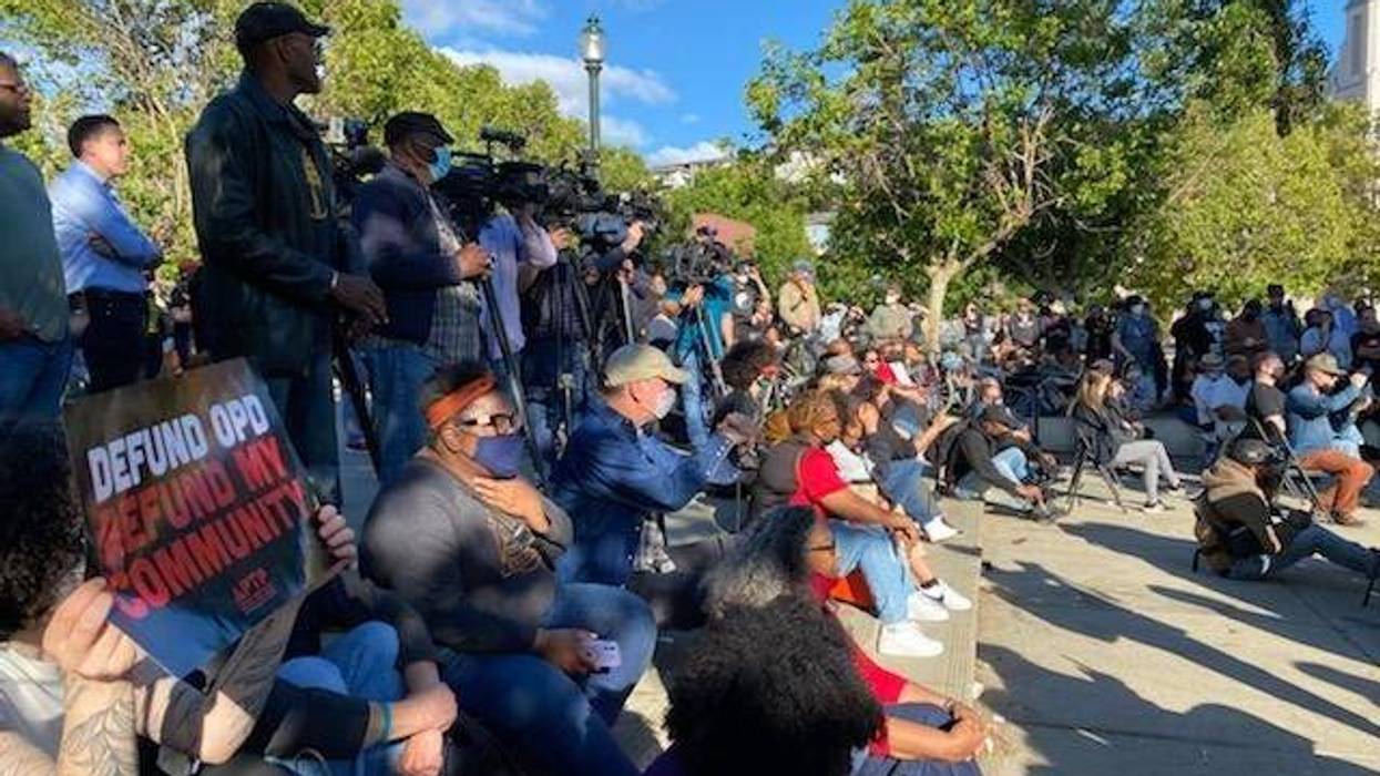 A few hundred people gather for a vigil at Lake Merritt on Tuesday following the Juneteenth mass shooting.