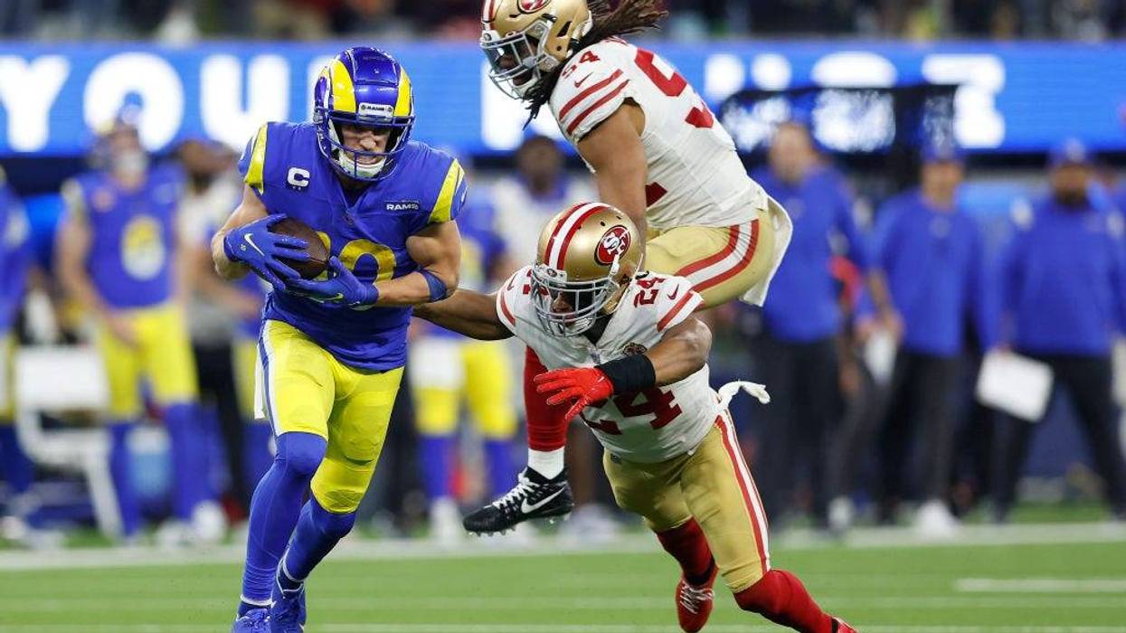 A file photo of Cooper Kupp #10 of the Los Angeles Rams running with the ball as Fred Warner #54 and K'Waun Williams #24 of the San Francisco 49ers defend in the NFC Championship Game at SoFi Stadium on January 30, 2022 in Inglewood, California