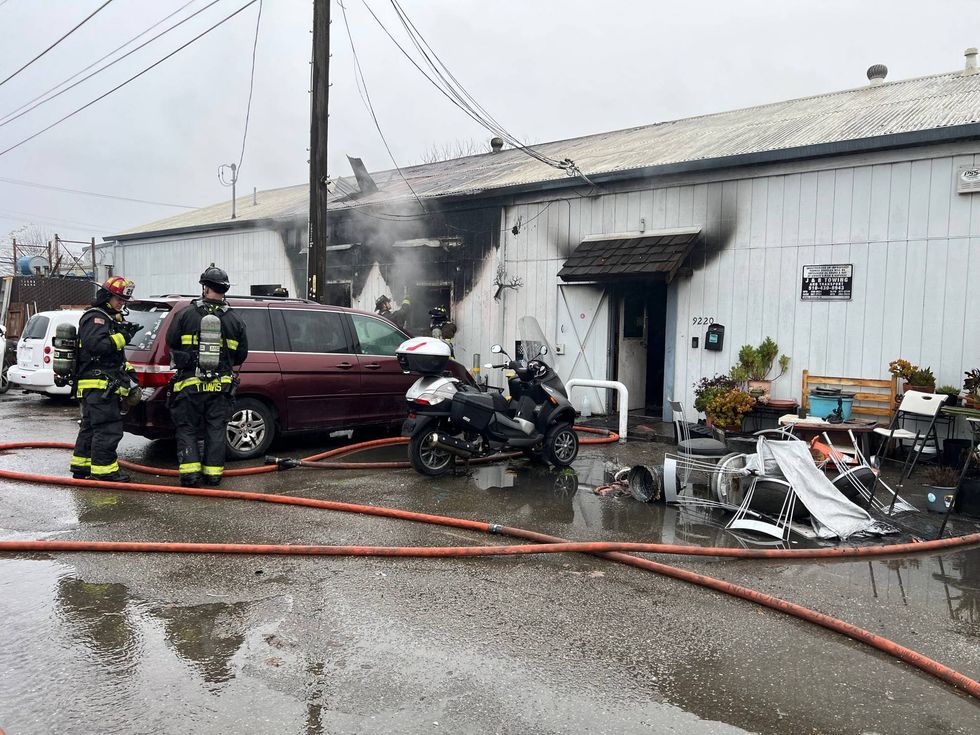 A fire destroyed a commercial building this morning in East Oakland, displacing people and animals.