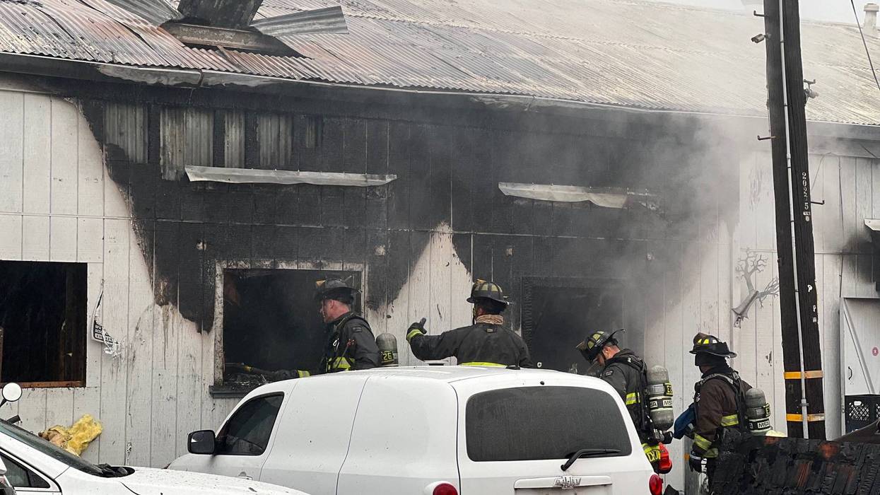 A fire destroyed a commercial building this morning in East Oakland, displacing people and animals.