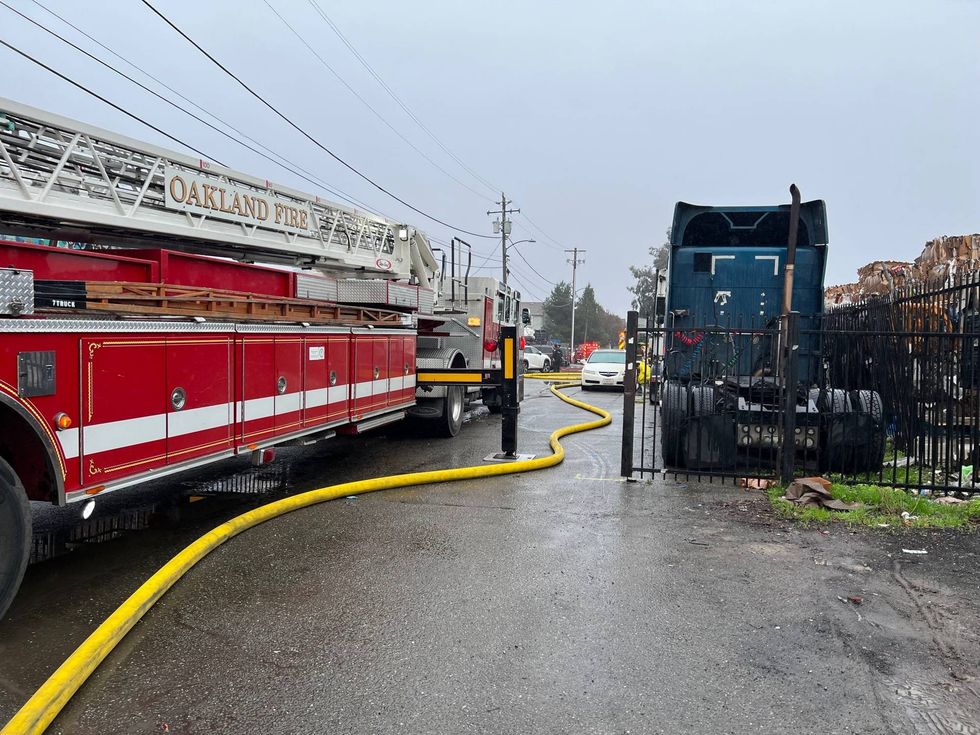 A fire destroyed a commercial building this morning in East Oakland, displacing people and animals.