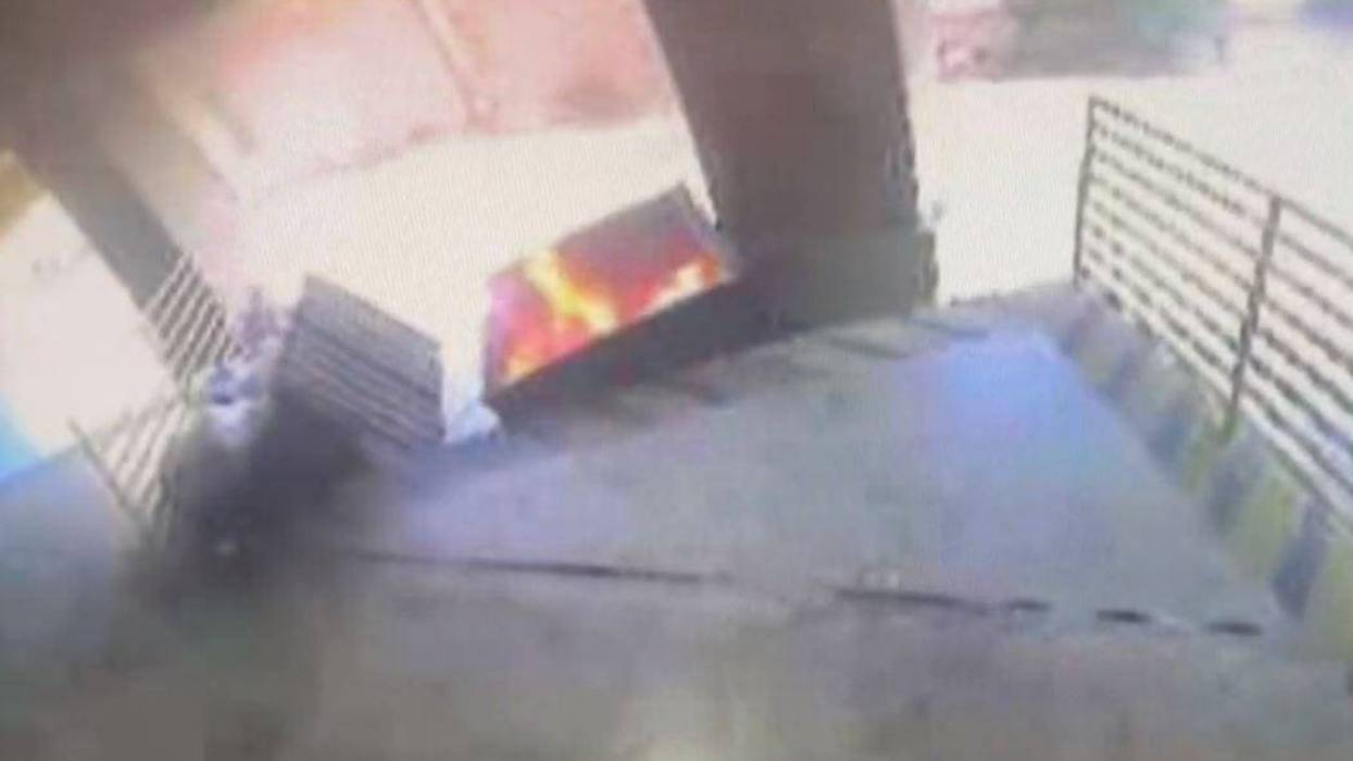 A fire in a dumpster behind the office of Texas Attorney General Ken Paxton on Wednesday, May 24, 2023.