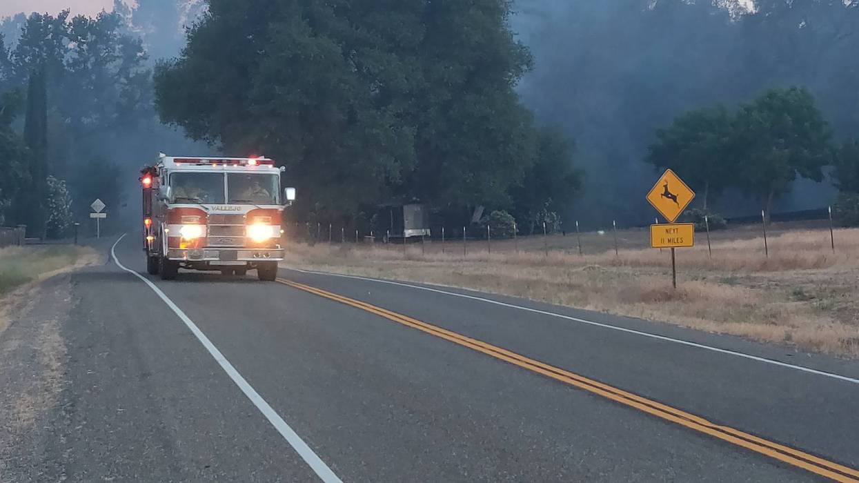 A fire rig speeds down a road as crews battle the Quail Fire in Solano County.