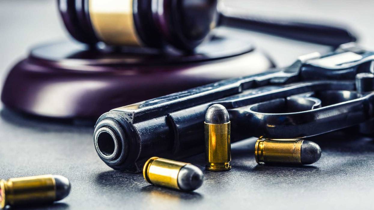 A firearm and gavel depicting gun laws.