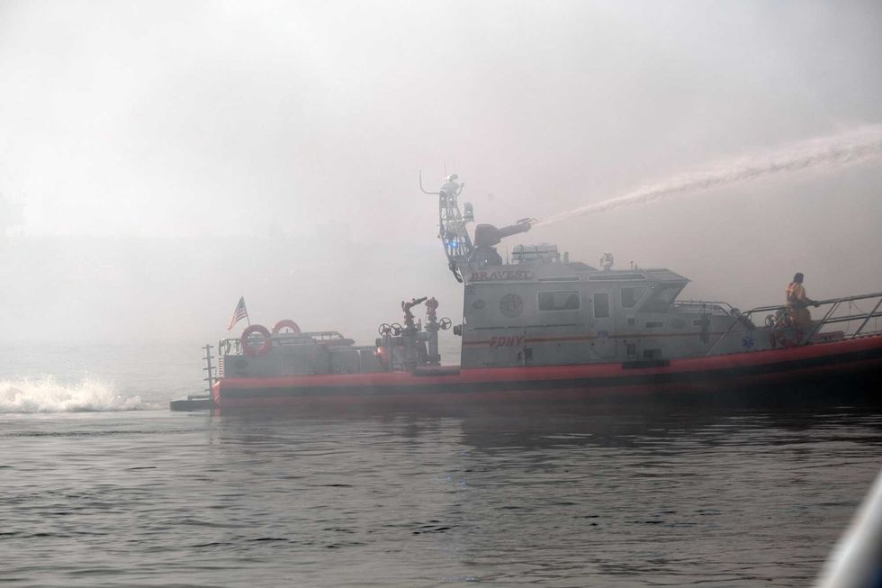 A fireboat works to control a large fire in the Brooklyn neighborhood of Red Hook on December 13, 2022