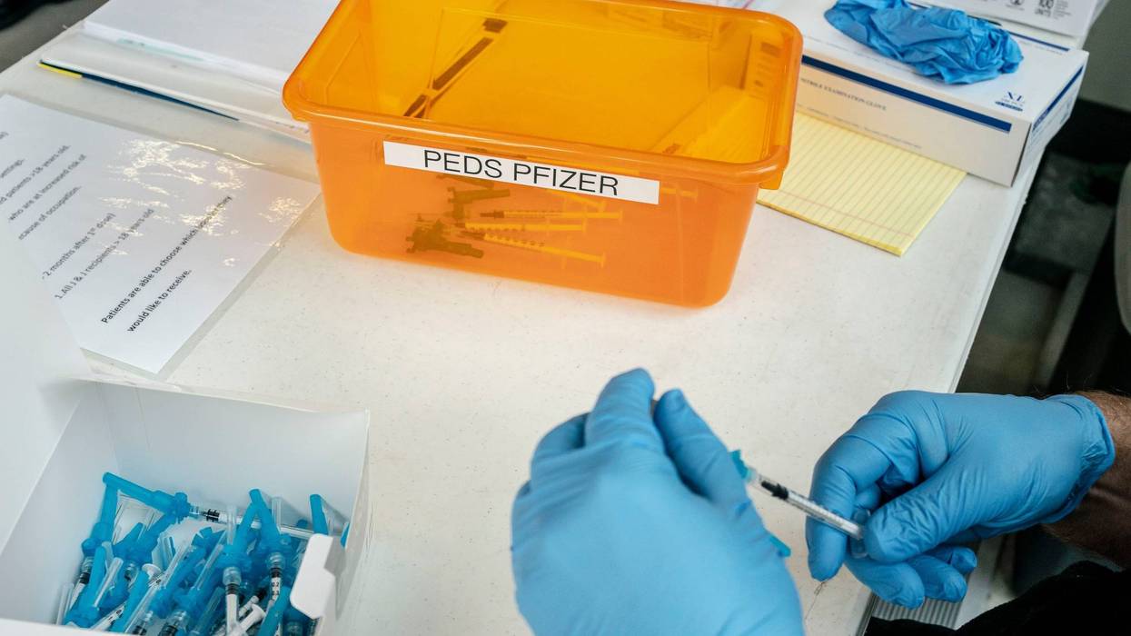 A firefighter prepares pediatric doses of the Pfizer-BioNtech Covid-19 vaccine on November 3, 2021 in Shoreline, Washington.