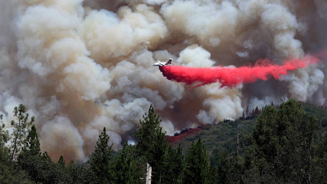 A firefighting aircraft drops retardant ahead of the Oak Fire on July 24, 2022 near Jerseydale, California.