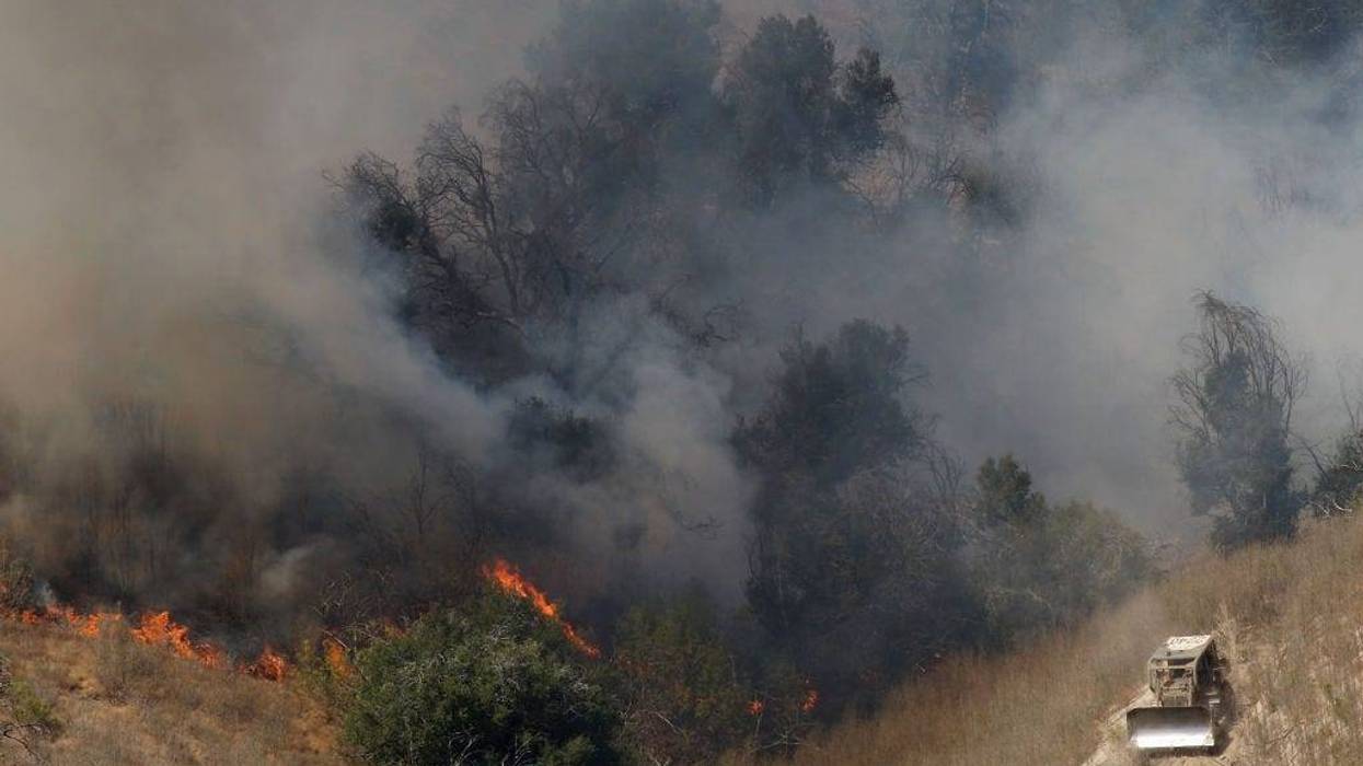 A firefighting bulldozer cuts a fire line on the southeastern flank of the nearly 10,000-acre Guiberson fire, burning out of control for a second day as Red Flag warnings continue in southern California on September 23, 2009 near Moorpark, California.