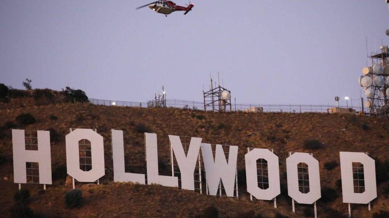 A firefighting helicopter flies near the Hollywood sign as the Barham fire burns nearby on November 09, 2019 in Los Angeles, California. The brush fire has burned roughly 34 acres of vegetation and appears to be under control.