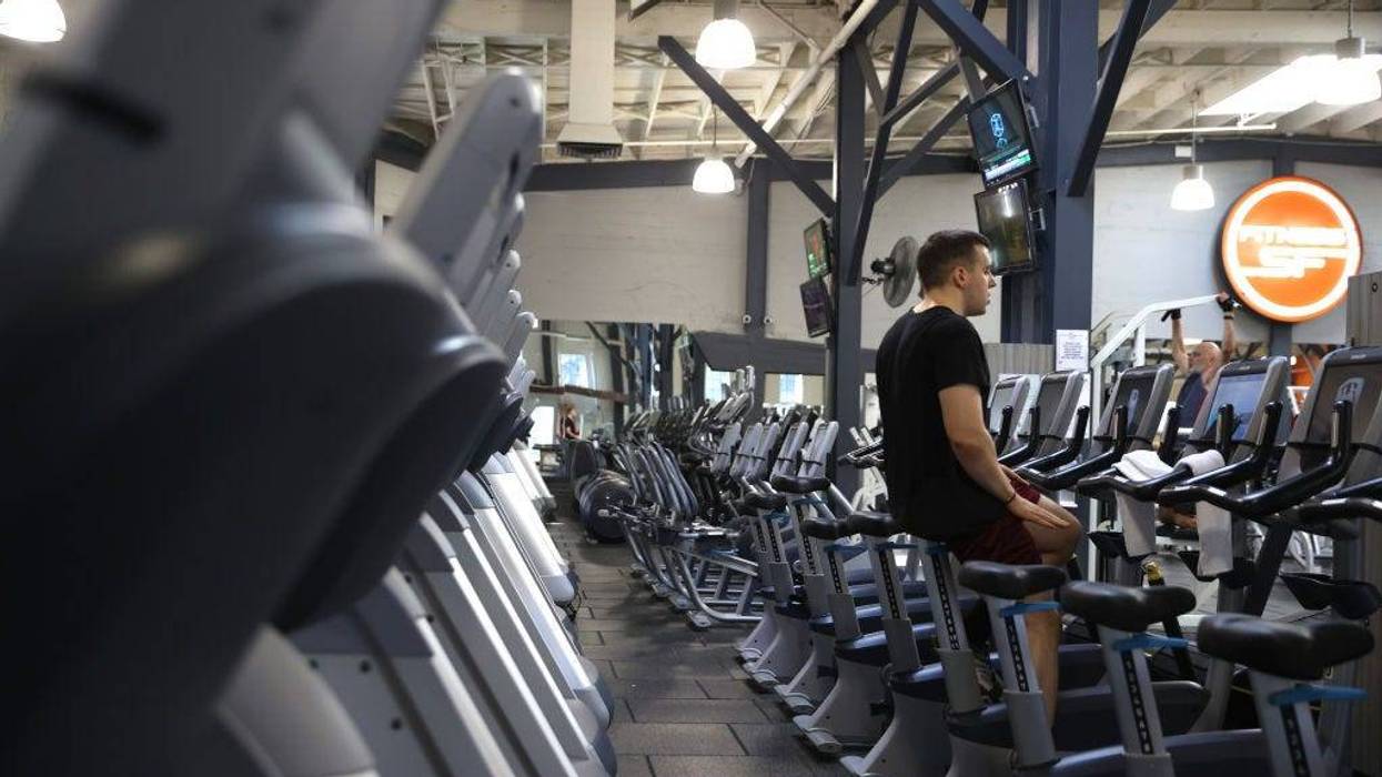 A Fitness SF customer rides a stationary bike without a face mask a Fitness SF gym on October 15, 2021 in San Francisco, California.