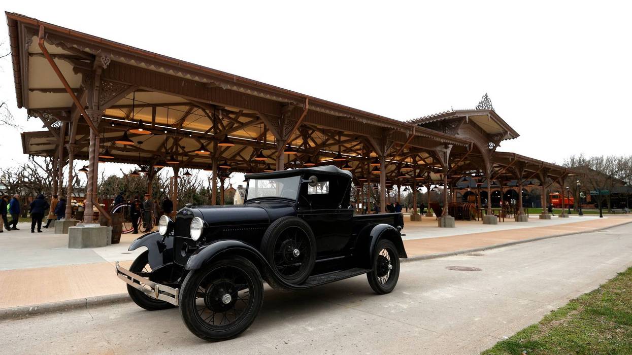 A Ford Model T is parked in front of the historic Detroit Central Market at Greenfield Village
