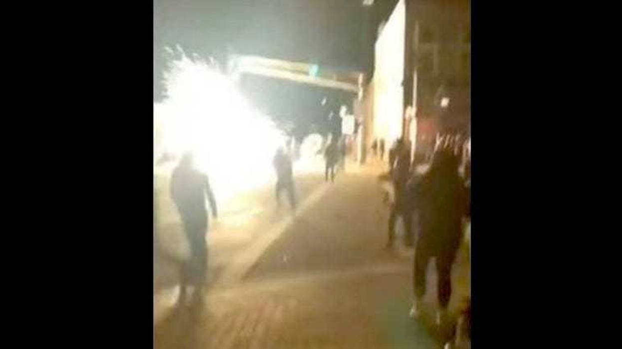 A frame of video posted to Facebook shows a firework explode near Naperville police during a June 1, 2020, protest in the western suburb.