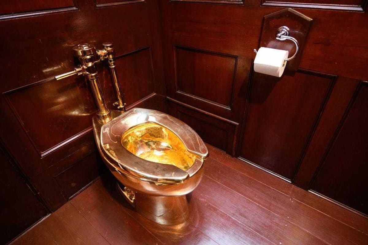 A fully-working solid gold toilet, created by Maurizio Cattelan, is seen at Benheim Palace on September 12, 2019 in Woodstock, England.