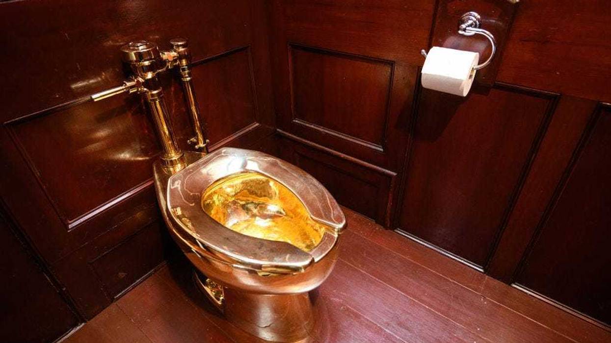 A fully-working solid gold toilet, created by Maurizio Cattelan, is seen at Benheim Palace on September 12, 2019 in Woodstock, England.