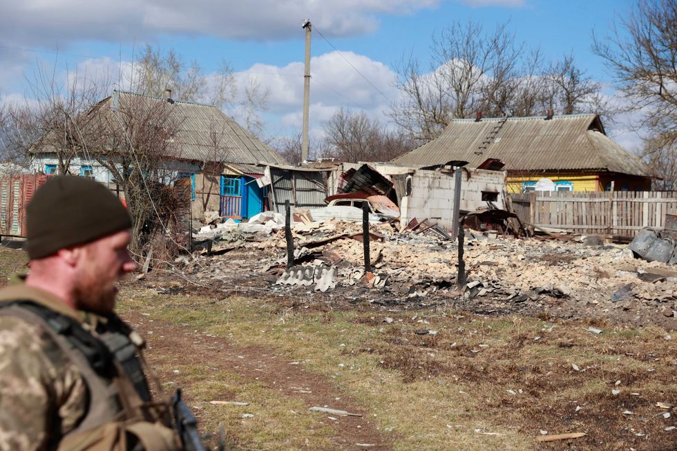 A garage with a car inside, damaged by fighting between Russian and Ukrainian troops in Lukyanivka, Kyiv region, Ukraine, Monday, March 27, 2022