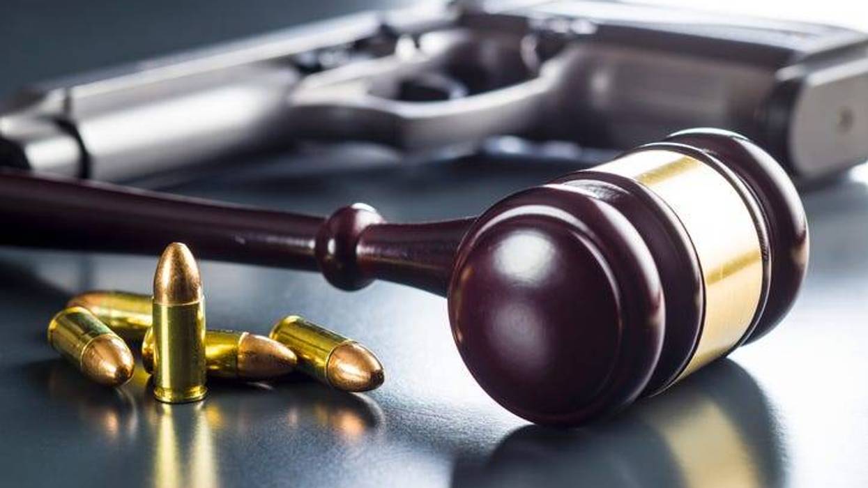 a gavel, bullets and a gun