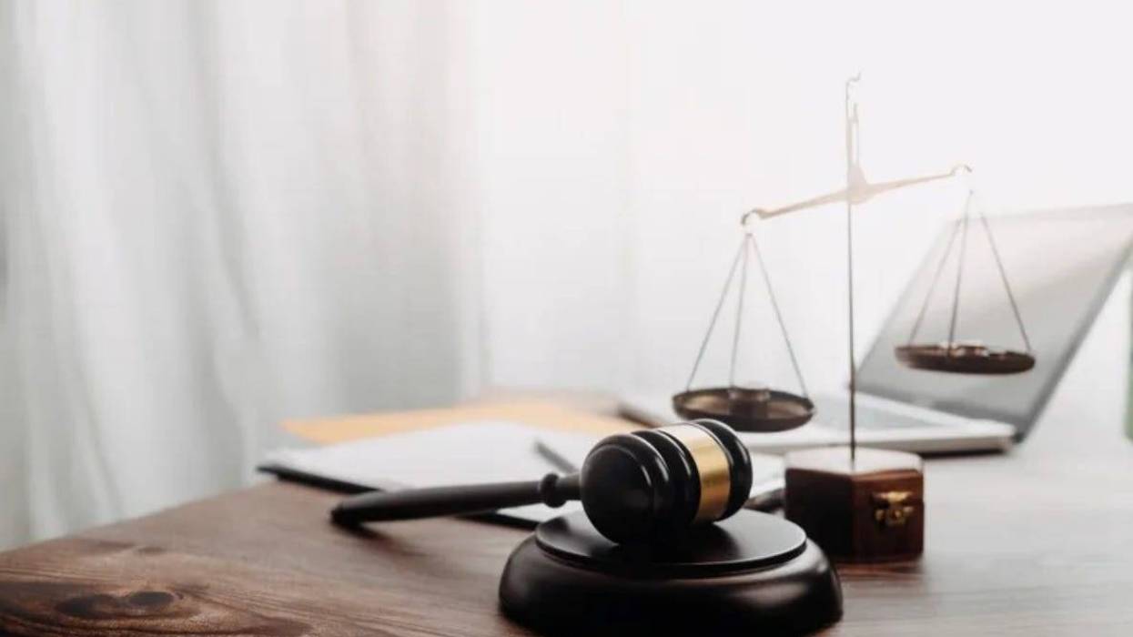 A gavel sits by scales