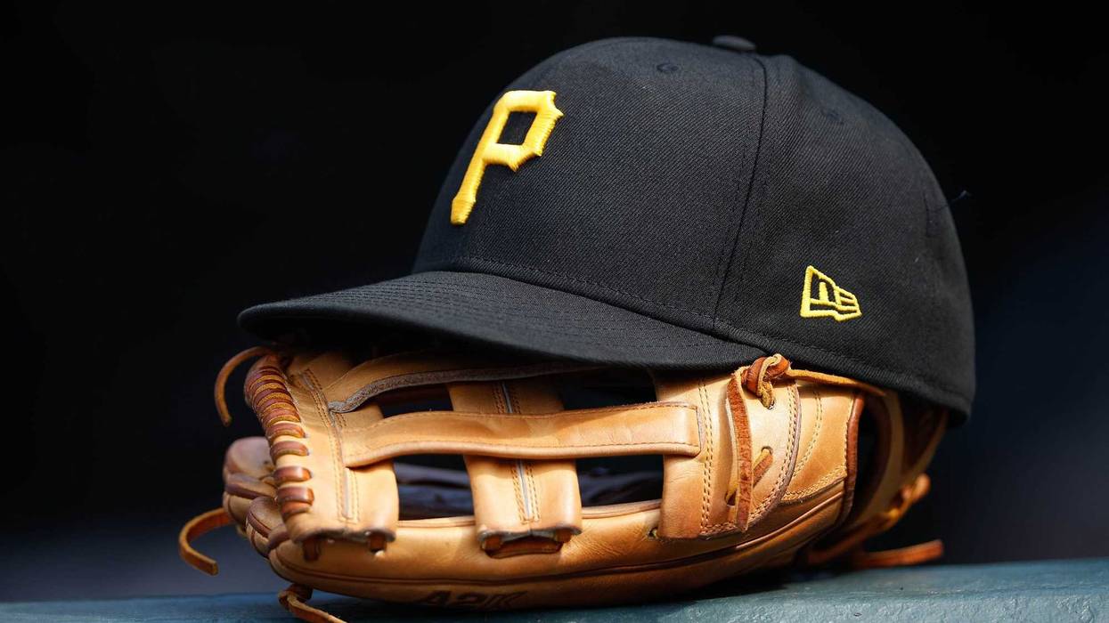 A general view of a Pittsburgh Pirates glove and hat in the eighth inning against the Colorado Rockies at Coors Field.