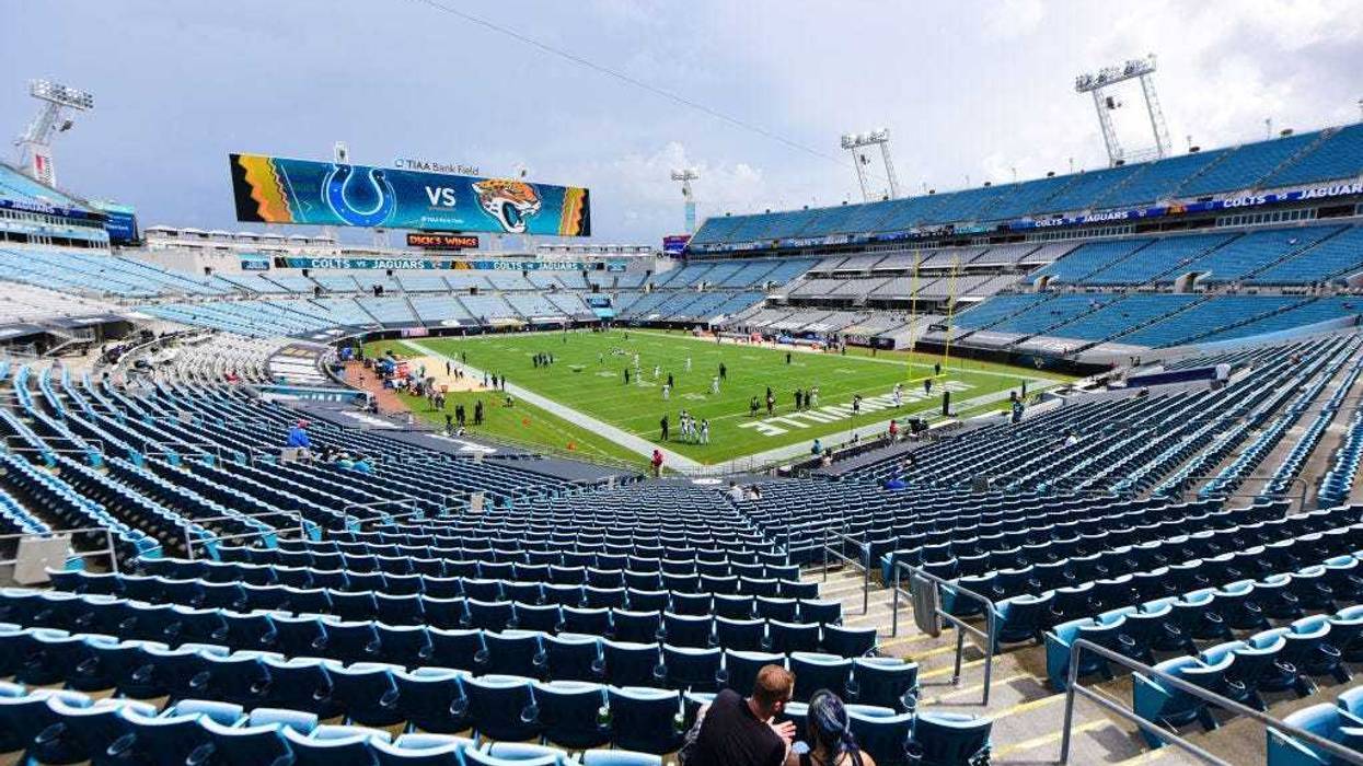 A general view of two fans sitting in an empty section at TIAA Bank Field before a game between the Jacksonville Jaguars and the Indianapolis Colts on September 13, 2020 in Jacksonville, Florida.