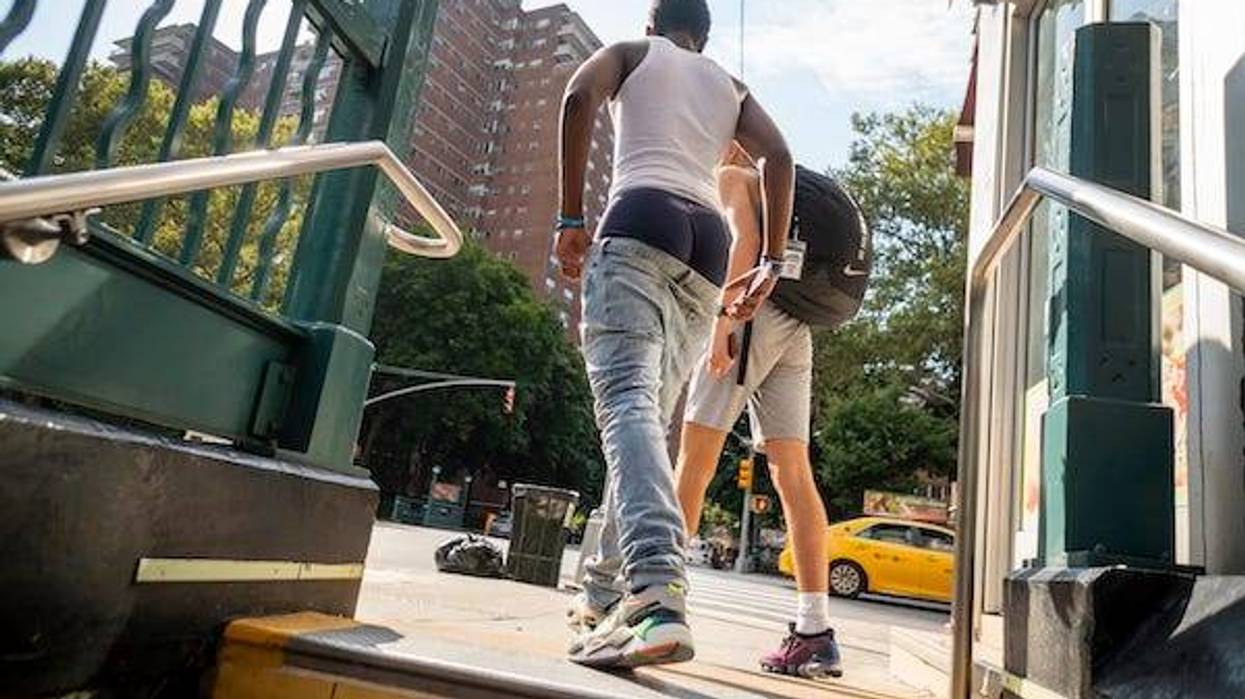 A gentleman in New York exits the subway showing off his sartorial splendor by wearing pants so baggie that they sag down showing his underwear