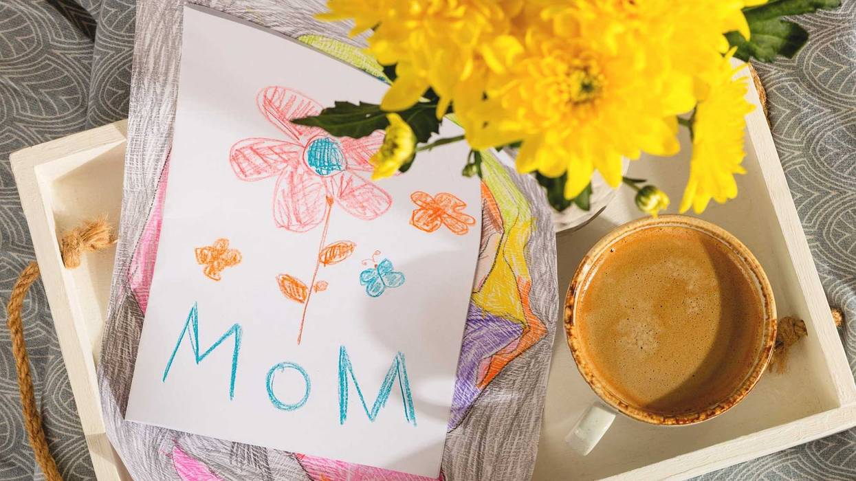 A gift from a child for mothers day - a card from a picture and coffee in bed in the morning. High quality photo