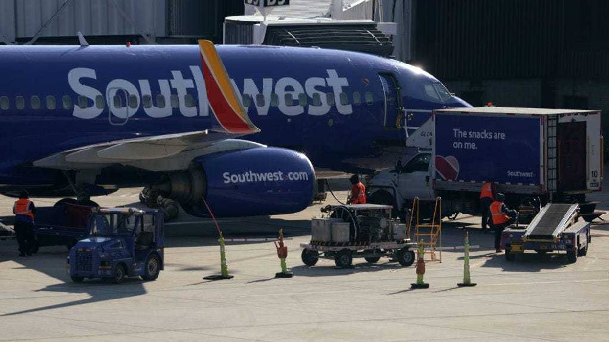 A ground crew replenishes a Southwest Airlines aircraft at Baltimore/Washington International Thurgood Marshall Airport (BWI) on December 22, 2021 in Baltimore, Maryland.