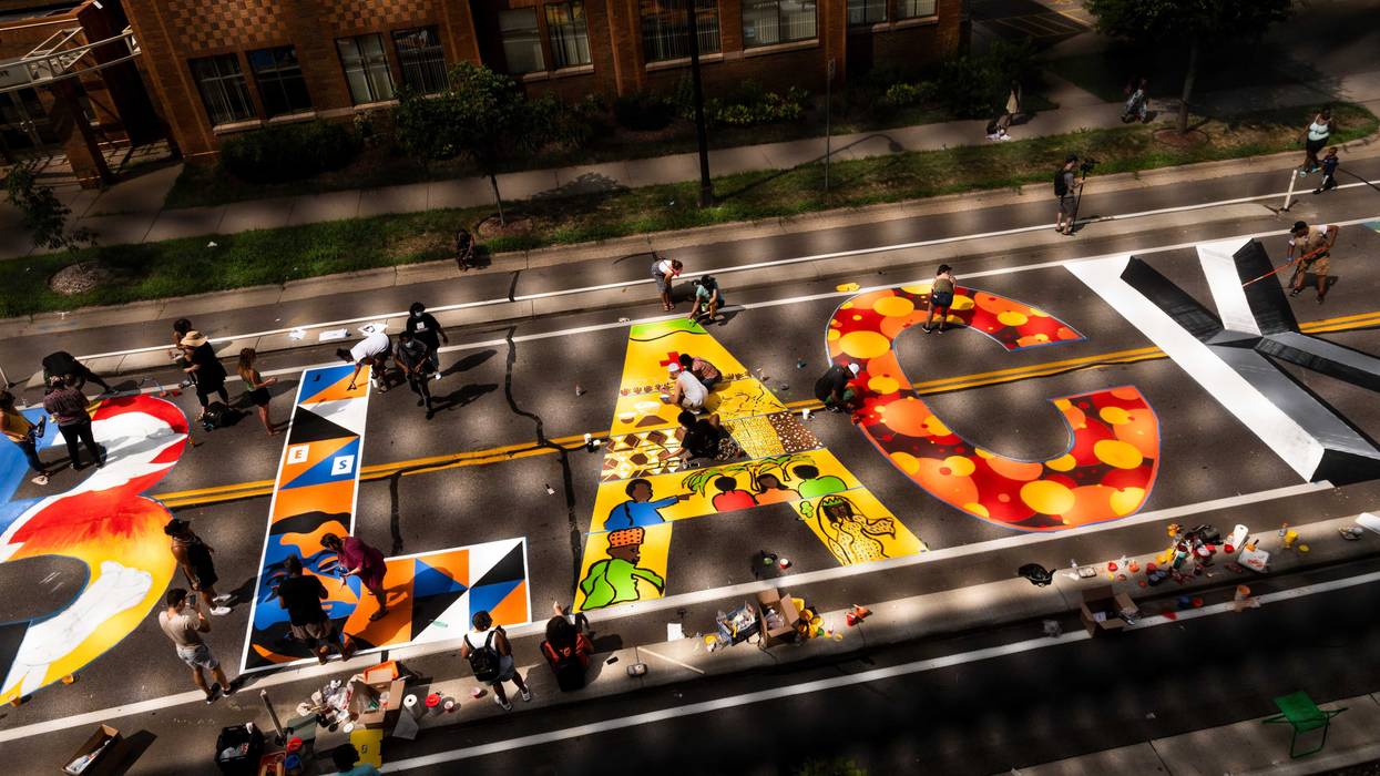 A group of artists and volunteers paint a Black Lives Matter mural on the street outside the Minnesota African American Heritage Museum and Gallery on July 18, 2020 in Minneapolis, Minnesota. The mural will be painted by 16 artists, who will each create their own individual artwork on a letter.