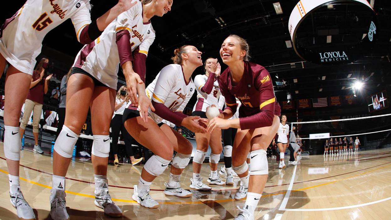 A group of Loyola volleyball players on the court