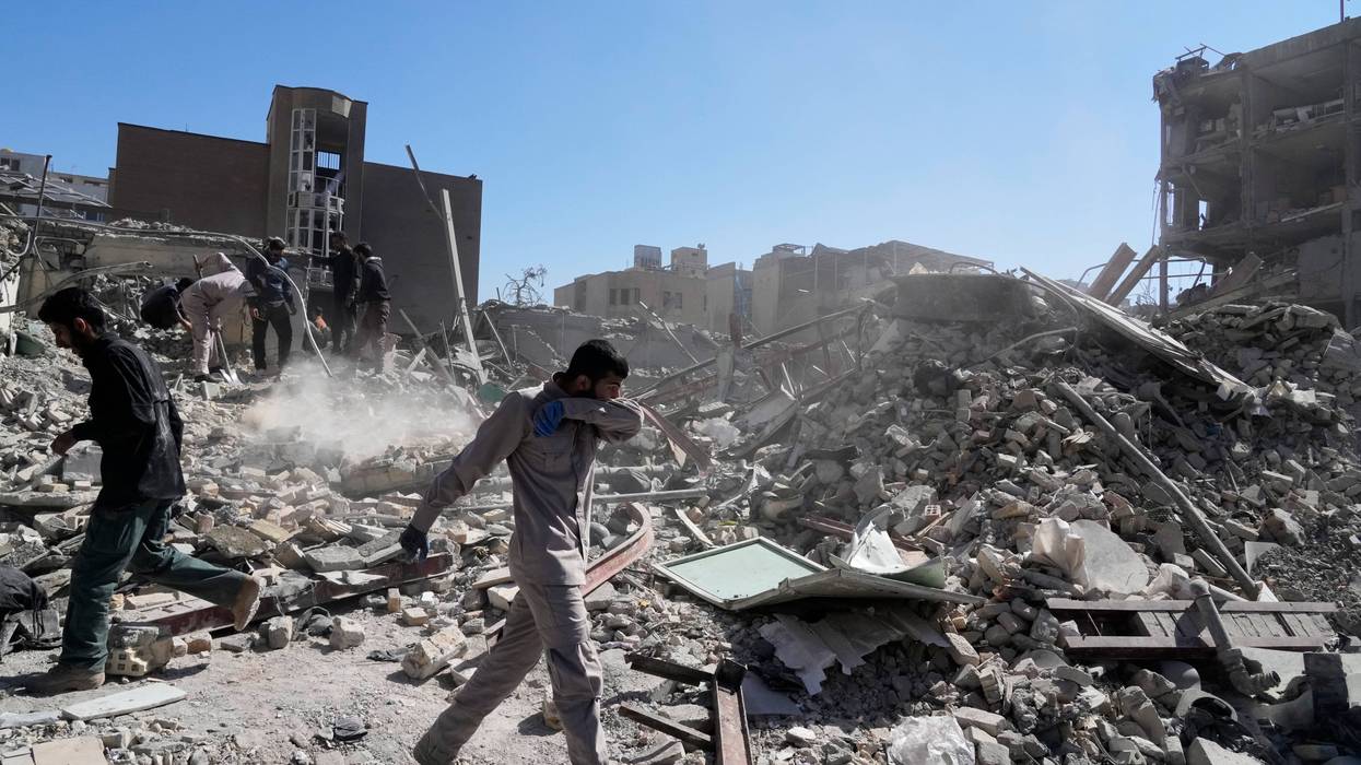 A group of men inspects the ruins of a police station struck Monday amid the U.S.–Israeli military campaign in Tehran, Iran, Tuesday, March 3, 2026.