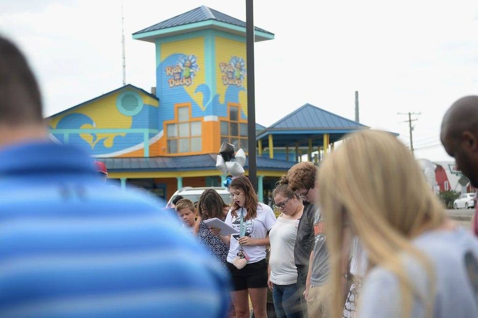 A group of mourners pause for a moment of prayer and remembrance of the victims of the Ride The Ducks accident at Ride The Ducks Tours on July 20, 2018 in Branson, Missouri.