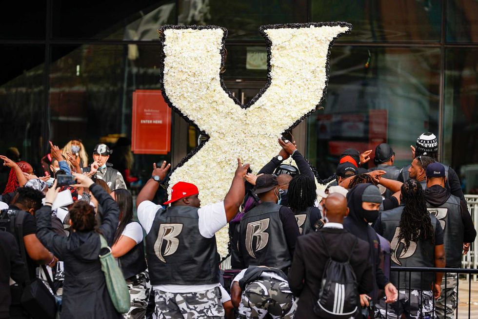 A group of mourners pay tribute during the Memorial Service Held For Rapper DMX at Barclays Center on April 24, 2021 in New York City
