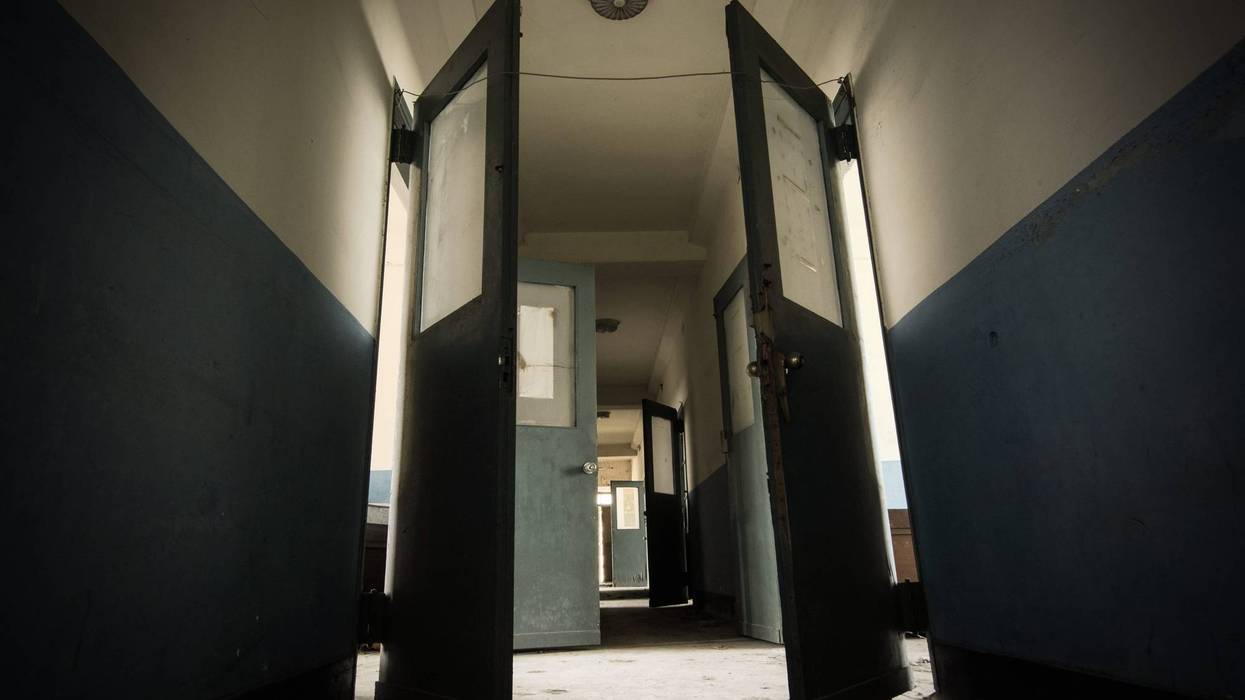 A group of people caught running away from flames at a defunct Metro Detroit psychiatric hospital were taken into police custody on Wednesday after police accuse them of intentionally set the blaze.