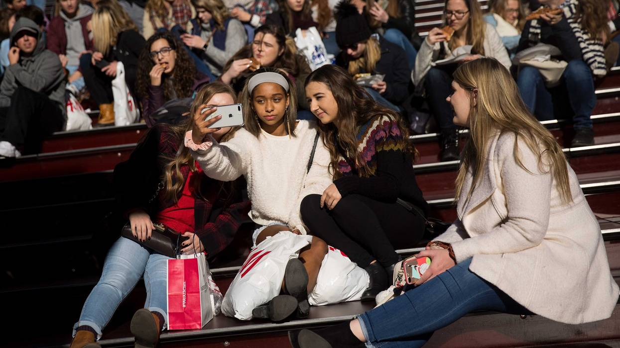 A group of teenagers take a selfie in New York City's Time Square