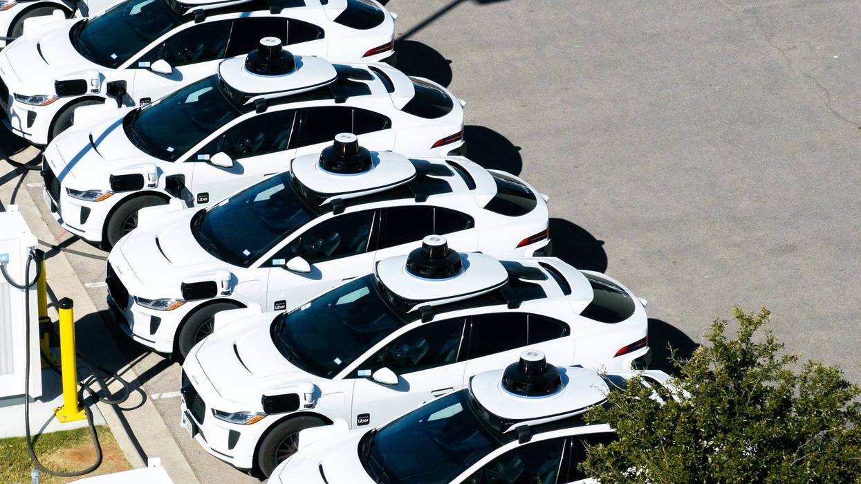 A group of Waymo driverless cabs parked in Austin, Texas.