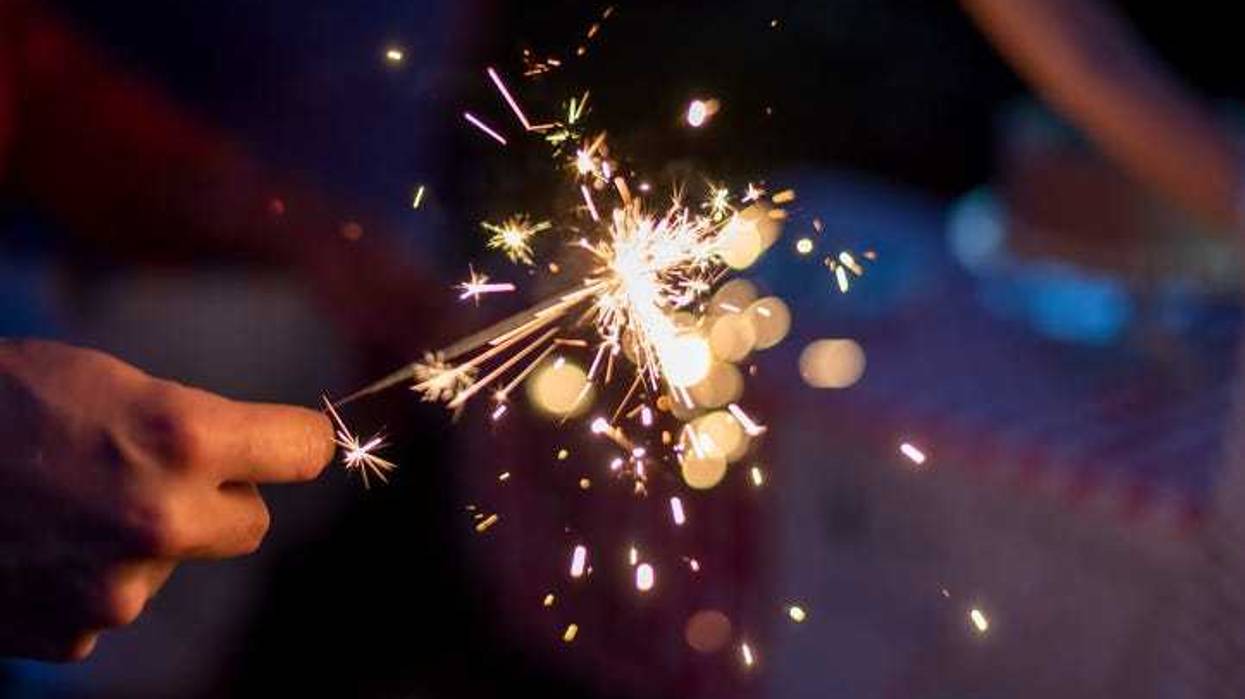 A hand holding a sparkler.