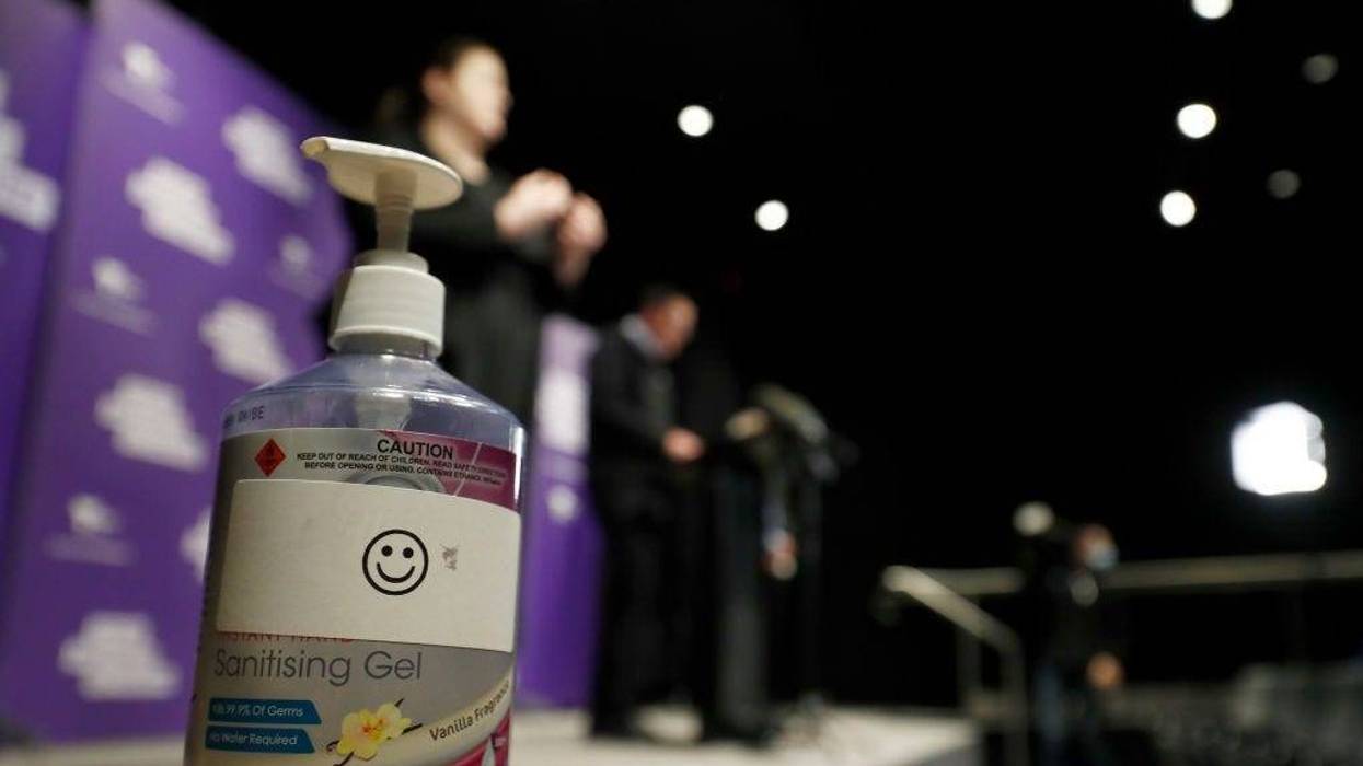 A hand sanitizer is seen as Victorian Premier Daniel Andrews speaks to the media during a daily briefing on July 25, 2020 in Melbourne, Australia.