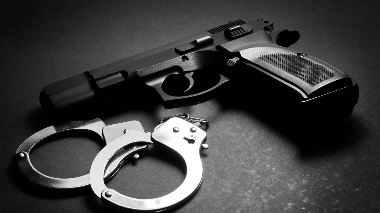A handgun and a pair of handcuffs