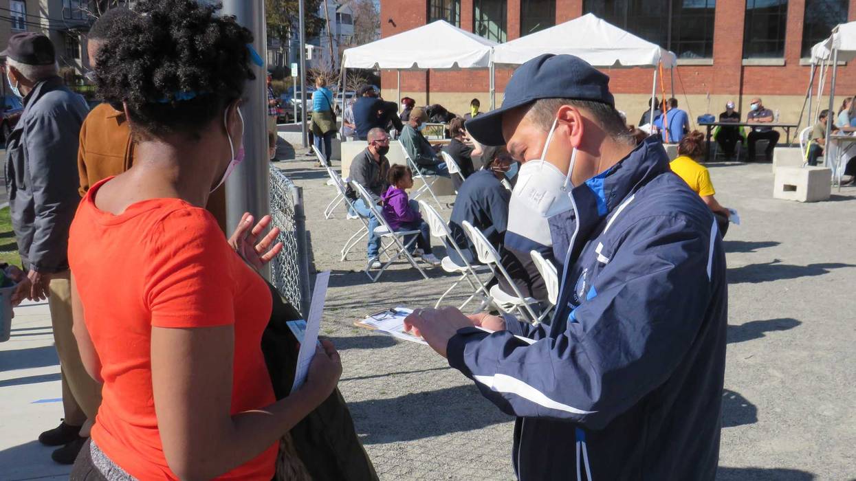 A Hartford Health Dept. employee registers a COVID-`19 vaccine recipient at a walk-up clinic in the Northeast neighborhood, 4/6/21.